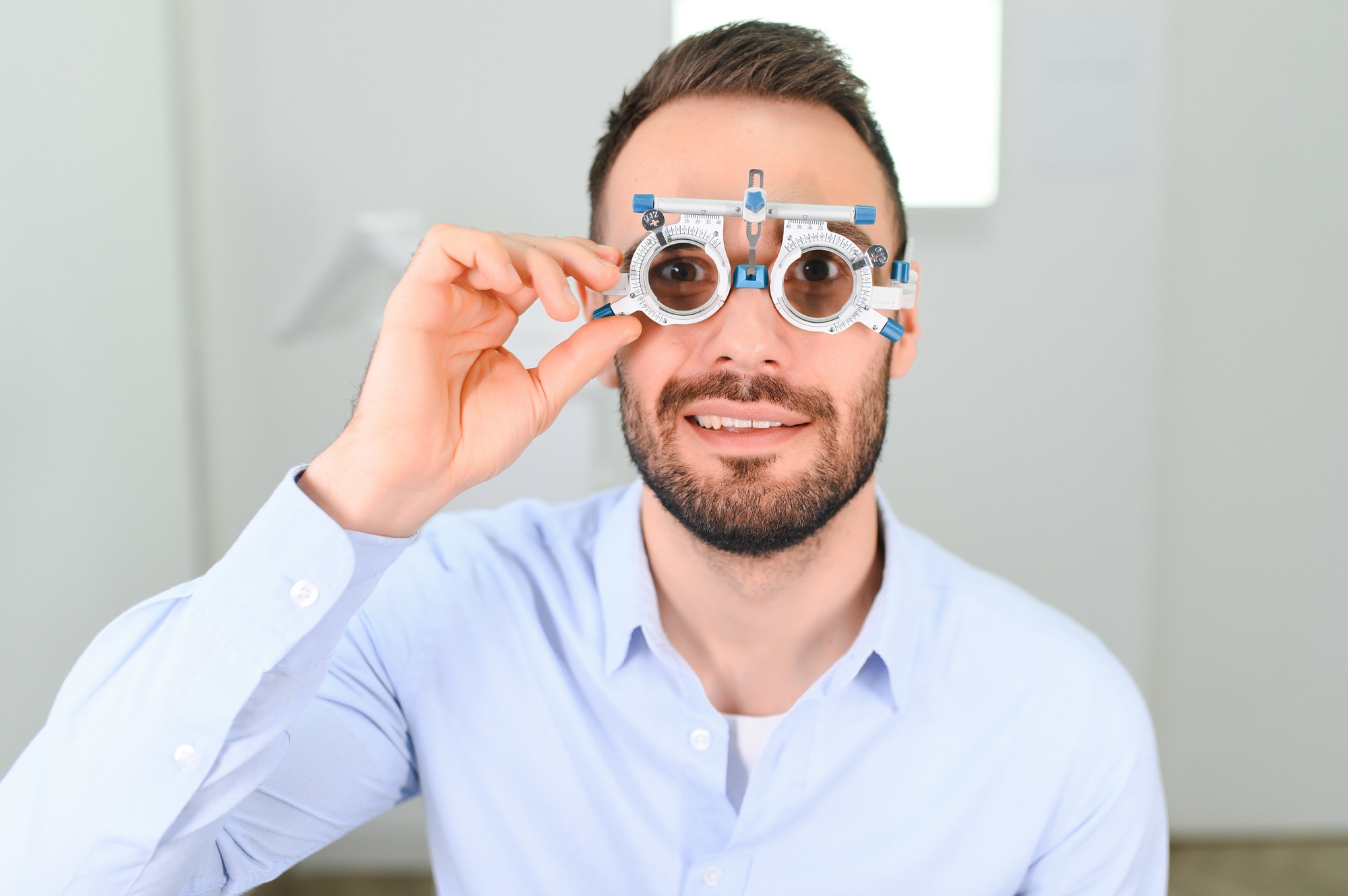 man checking up vision with special ophthalmic glasses