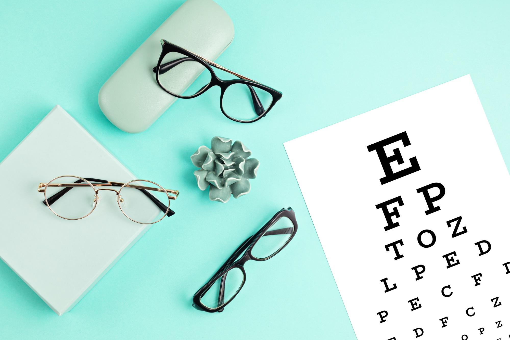 Collection of eyeglasses with eye test table. Optical store, glasses selection, eye test, vision